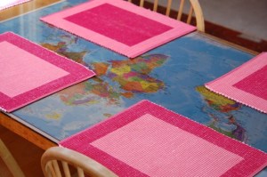 kitchen table with a world map under a sheet of glass